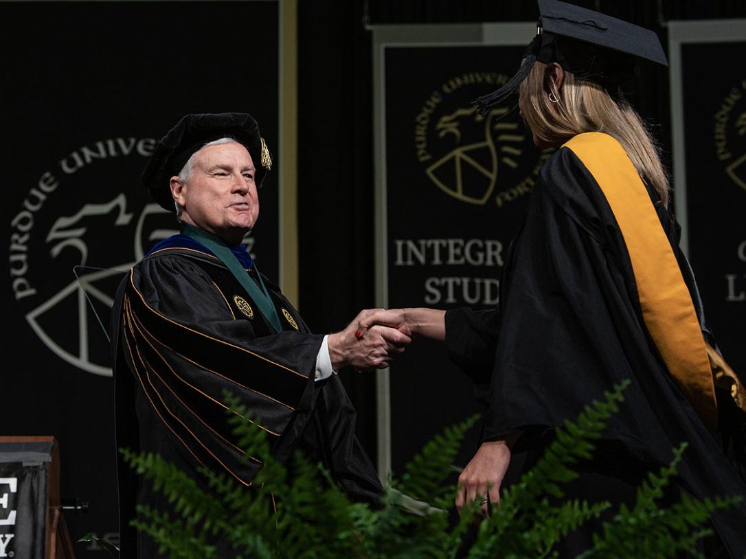Chancellor Elsenbaumer congratulates a graduate