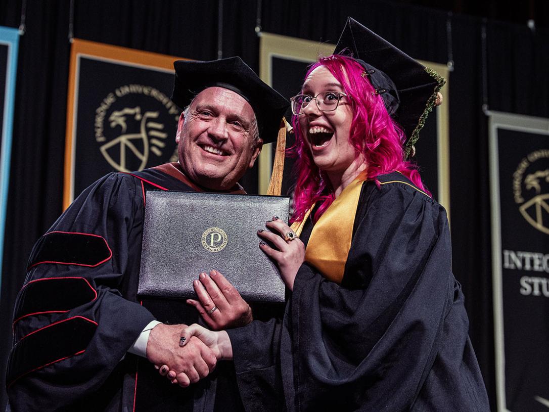 A student is awarded her diploma by the VPA dean