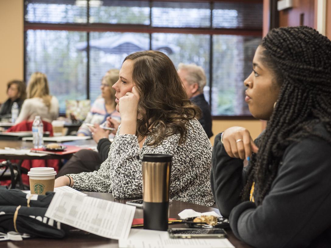 Counselors listening to a presentation about Collegiate Connection.