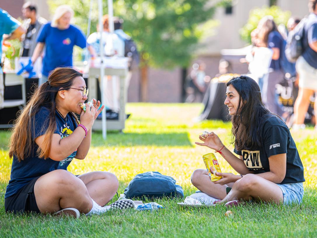 Students eating lunch outside at a student organizations fair on the PFW campus.