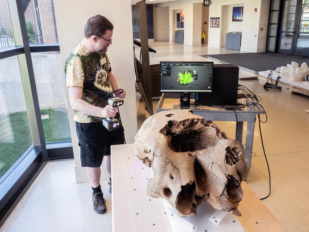 Graham Fredrick, library systems specialist, was part of a team including Erika Mann, director of library technology and digital initiatives, and Daniel Lin, information services technician, who scanned the baby mastodon’s skull for 3D digitization.