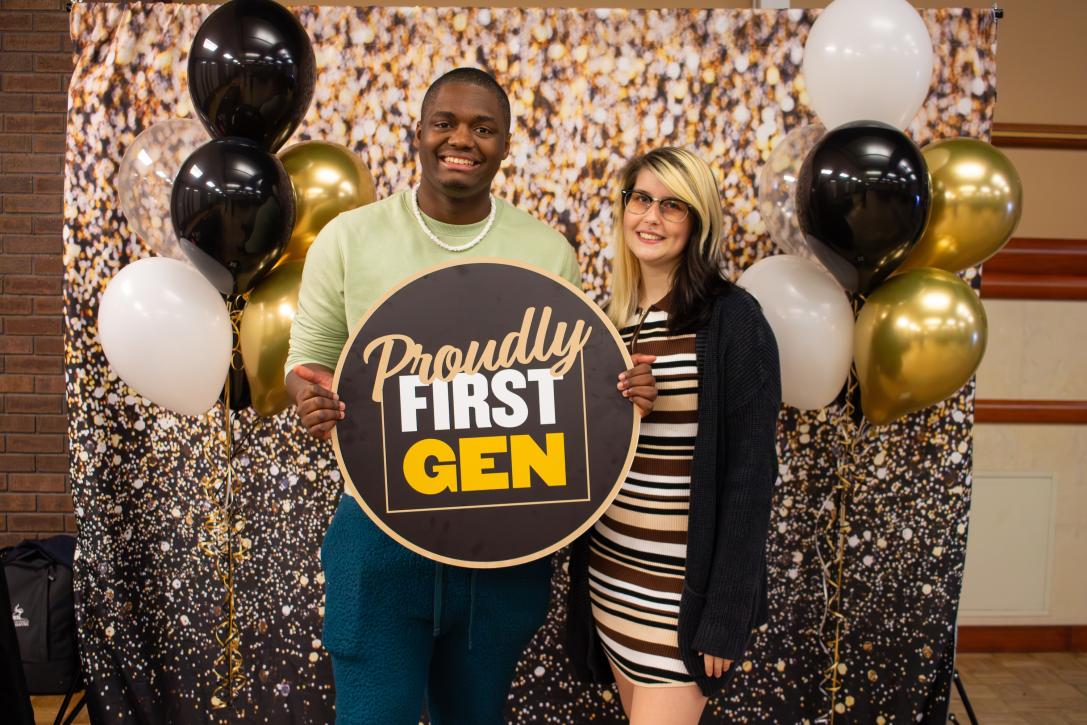 Students holding a First Gen sign.