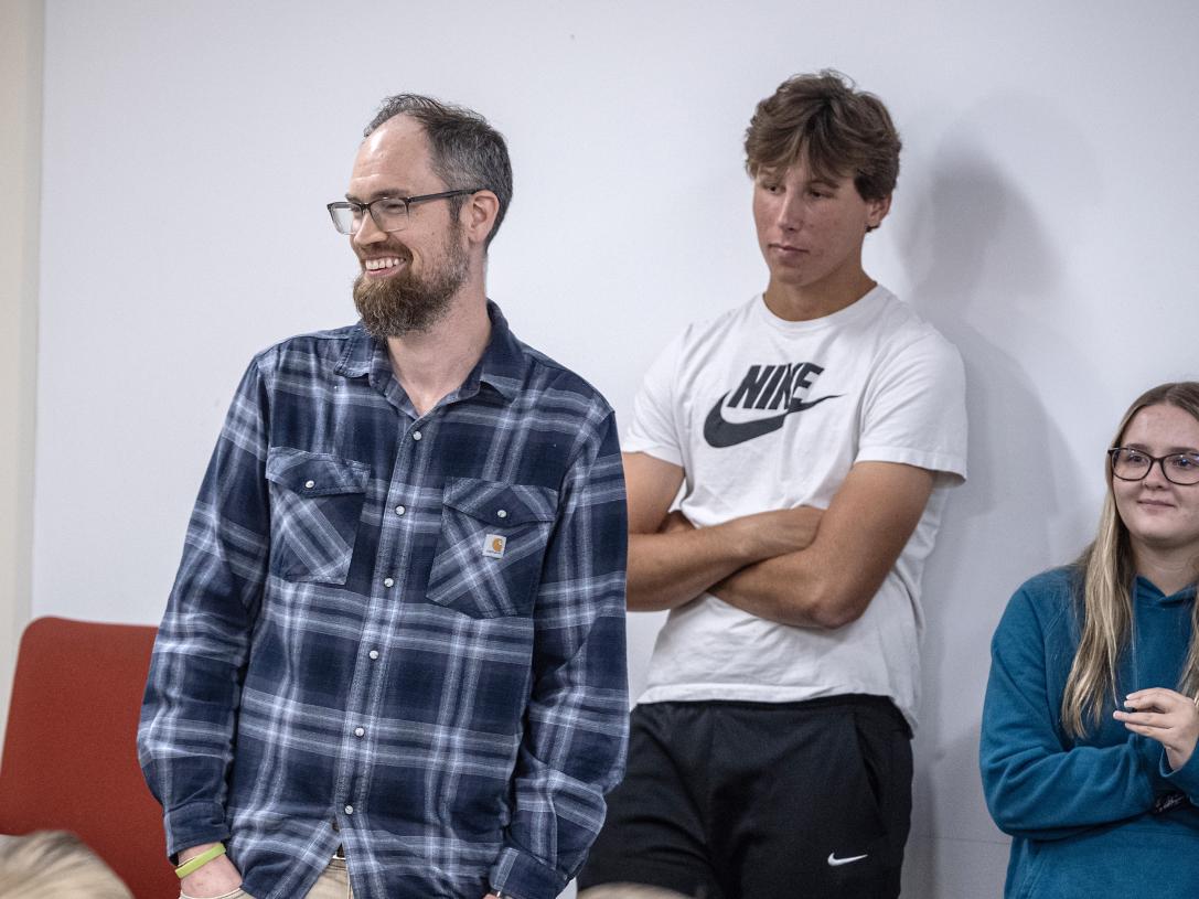 Students and professor standing in class