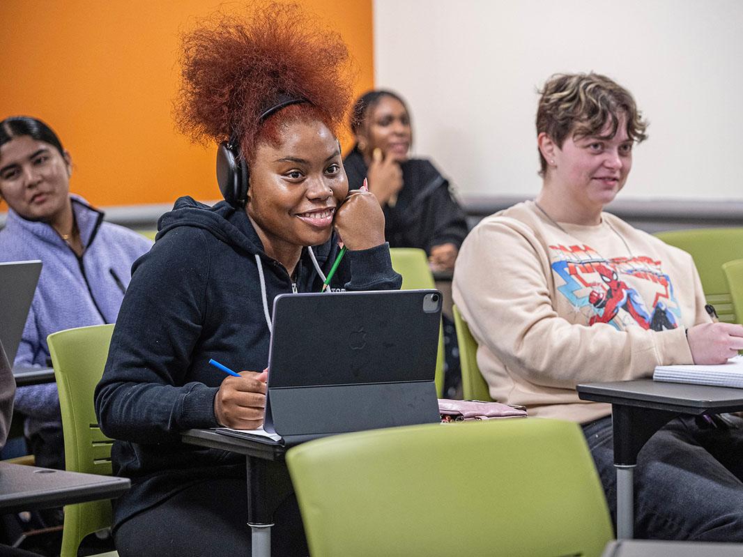 Smiling students in a classroom setting