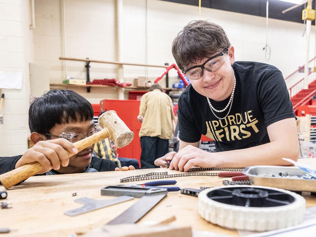 Drew Clem is working with robotics team students