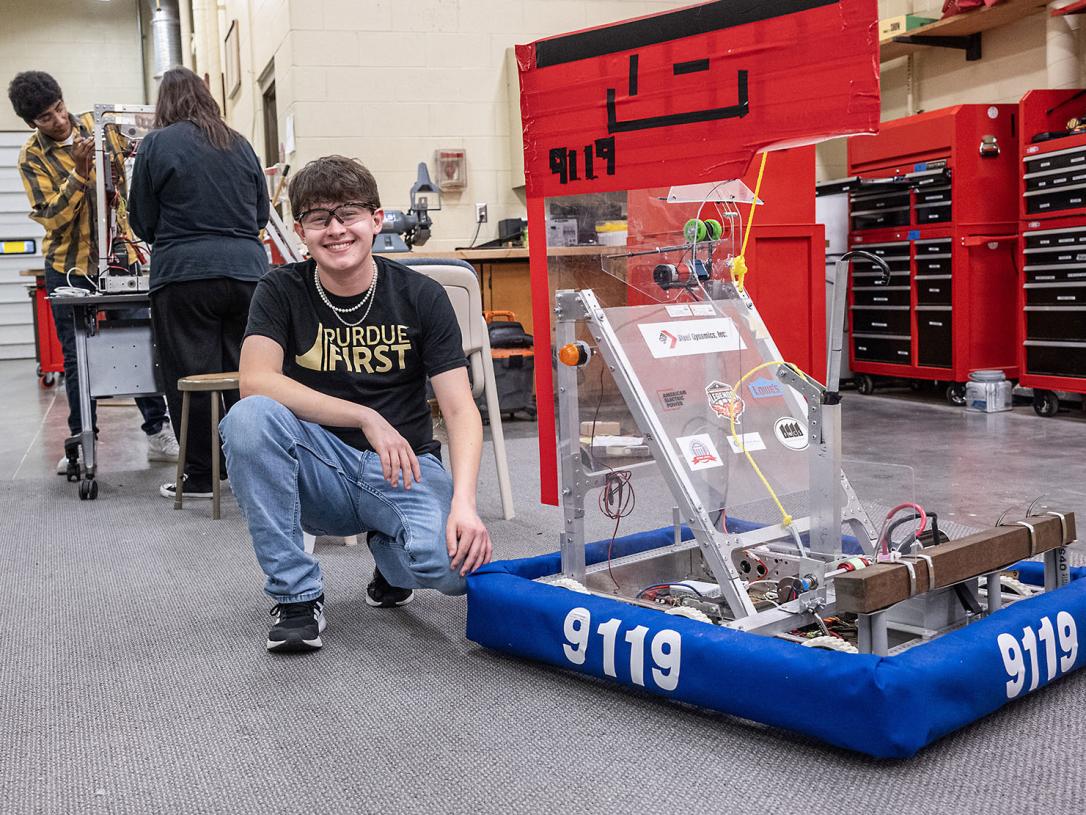 Drew Clem is working with robotics team students
