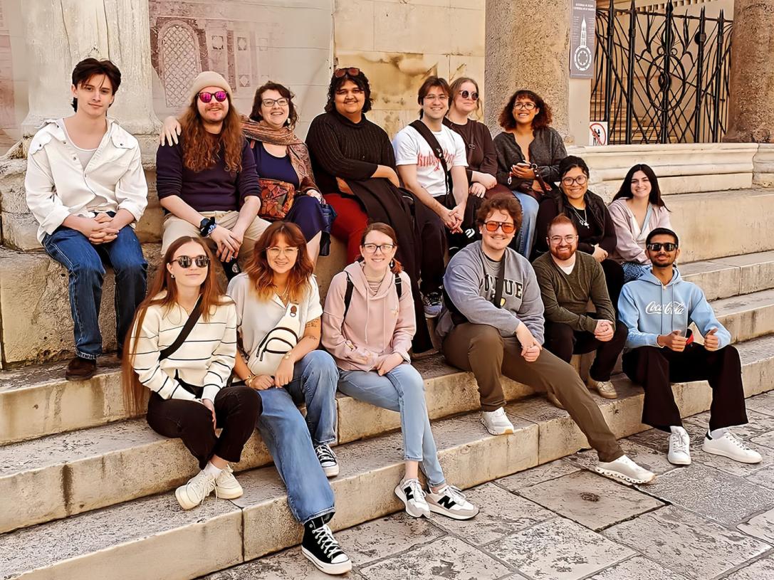 A group of PFW students sitting on stairsteps in Croatia