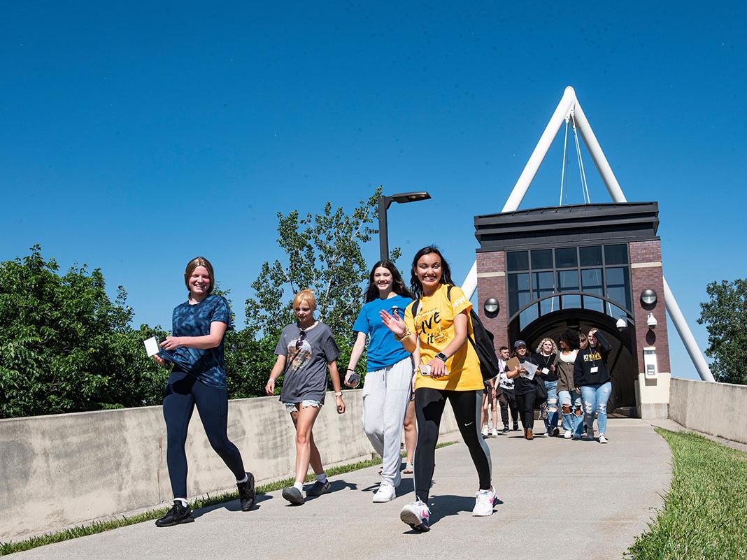 Students are walking near the pedestrian bridge
