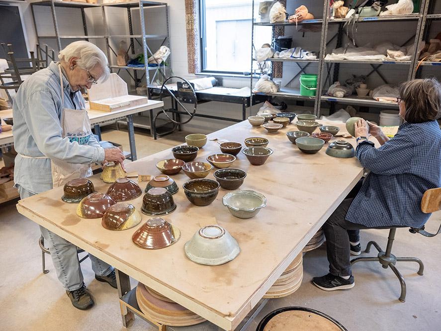 Checking the bowls after firing.