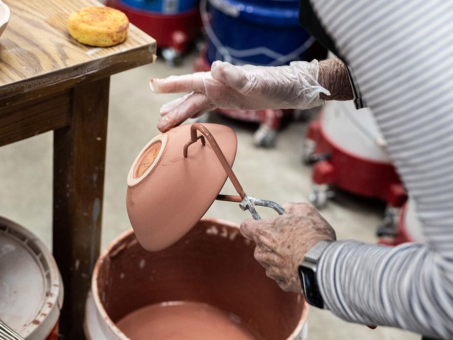 Dipping a bowl in glaze
