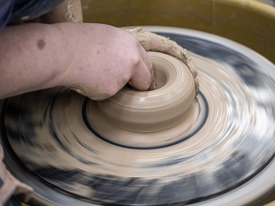 Turning a bowl on a pottery wheel.