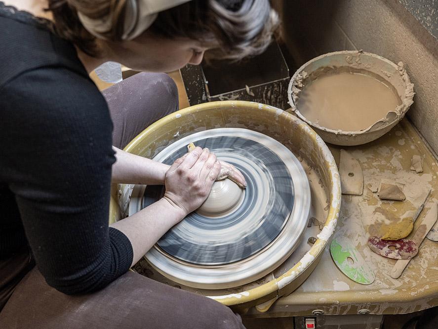 Turning a bowl on a pottery wheel.