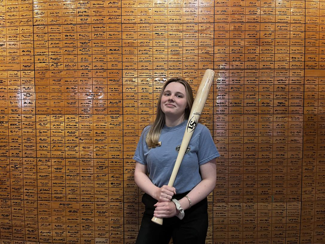 Hailey Bower holding a baseball bat