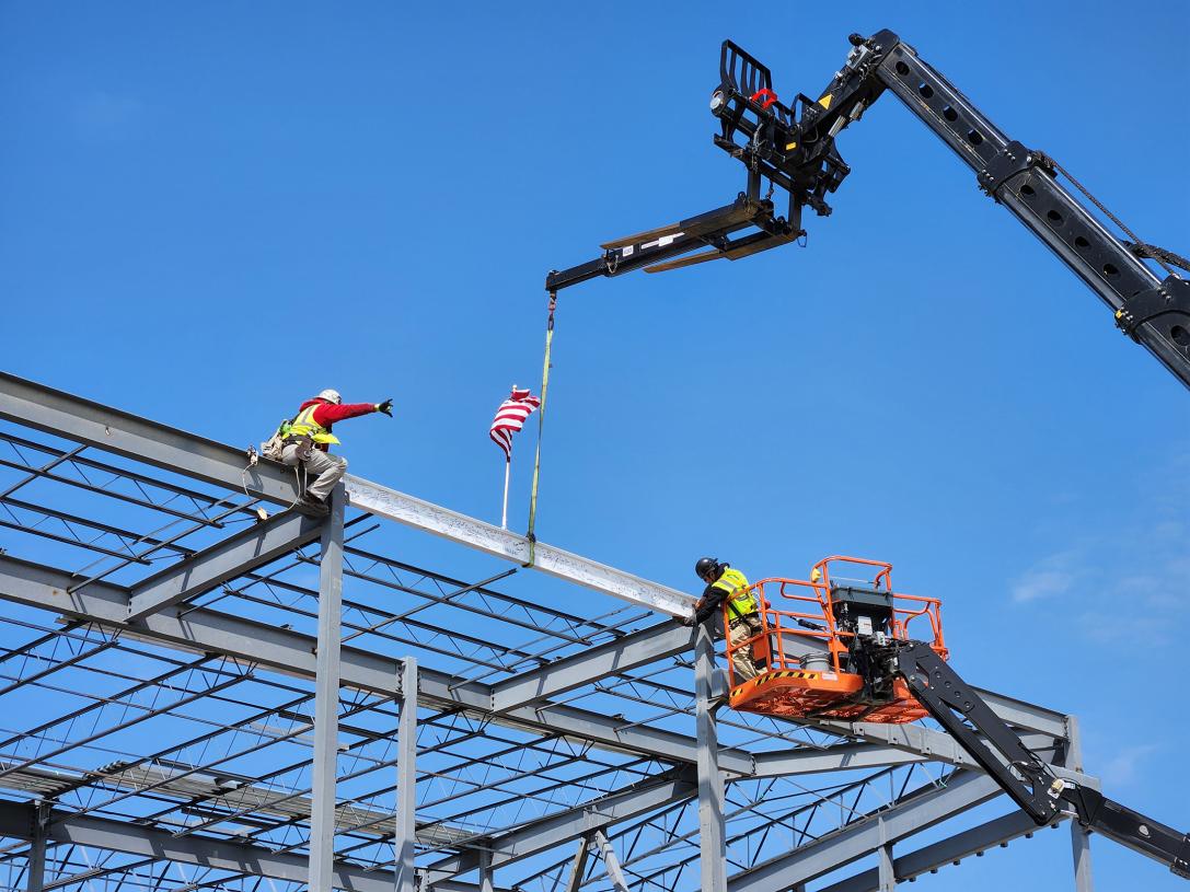 The final beam  is placed atop the Music Industry building