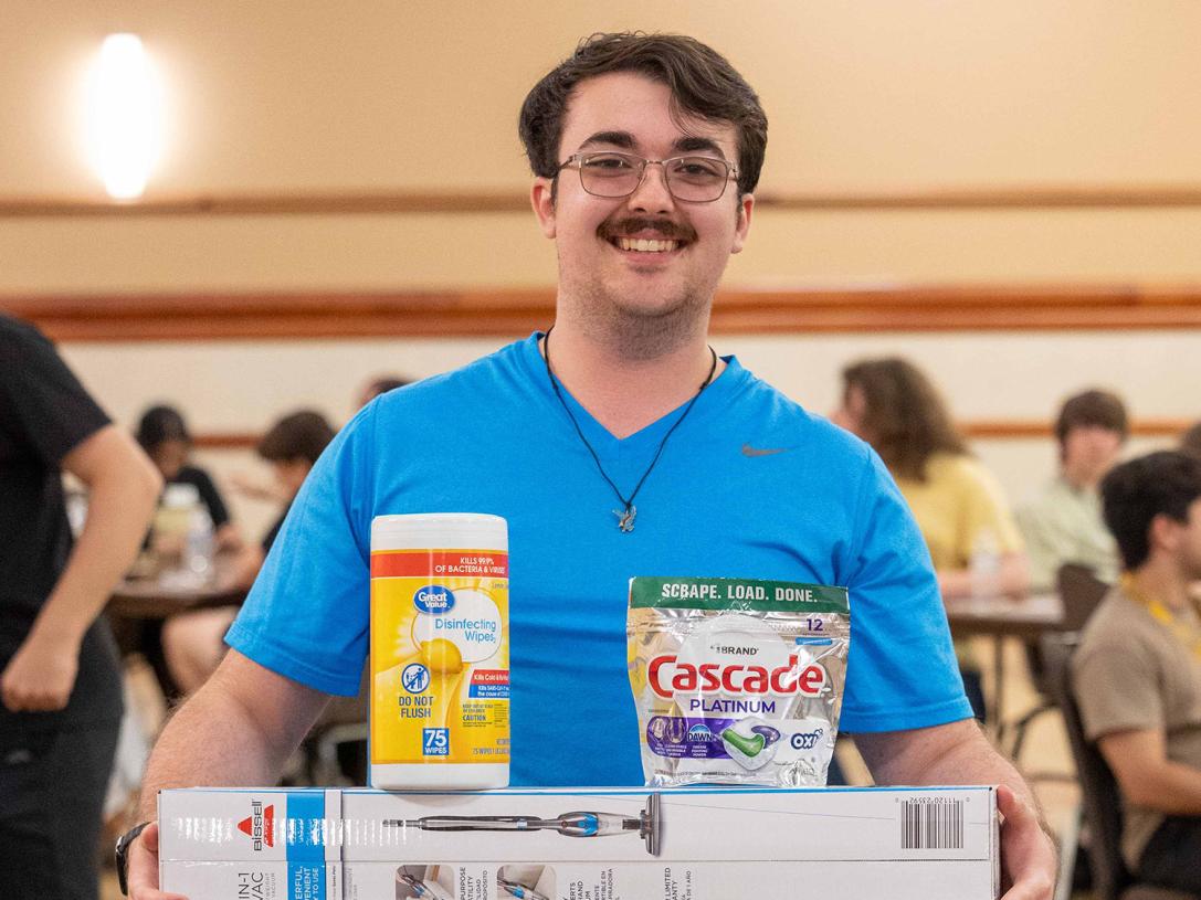 A new student is displaying his bingo prizes at NSO bingo night