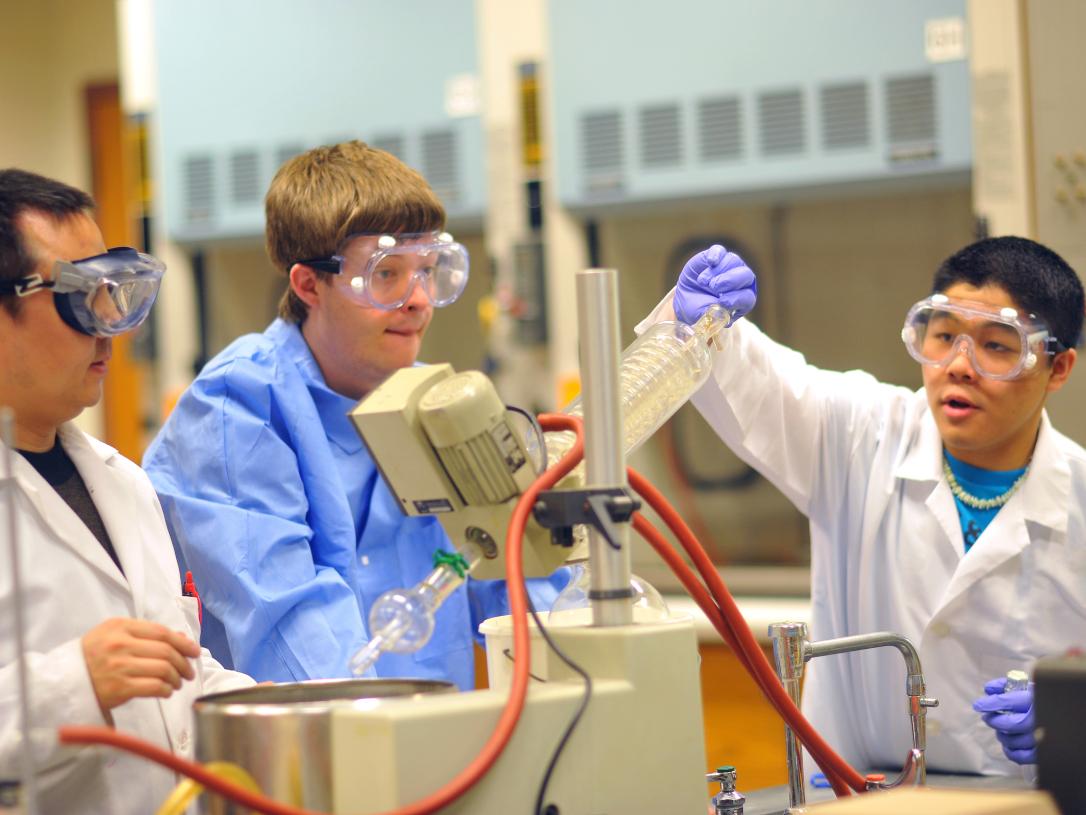 PFW students in a chemistry lab with safety protection goggles.