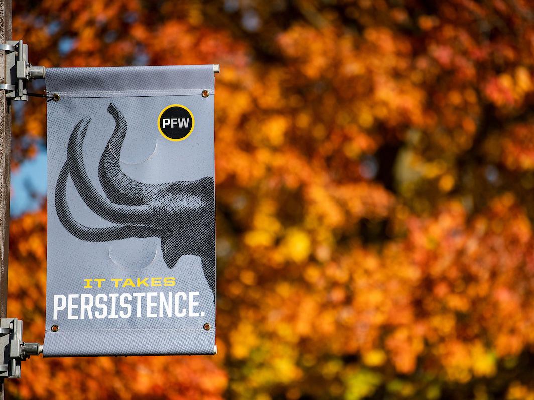 A mastodon banner backed up by fall foliage