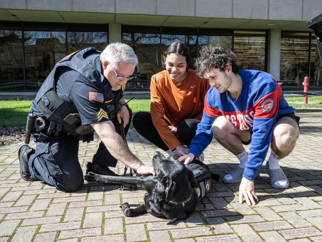 Students playing with Recon the police dog.