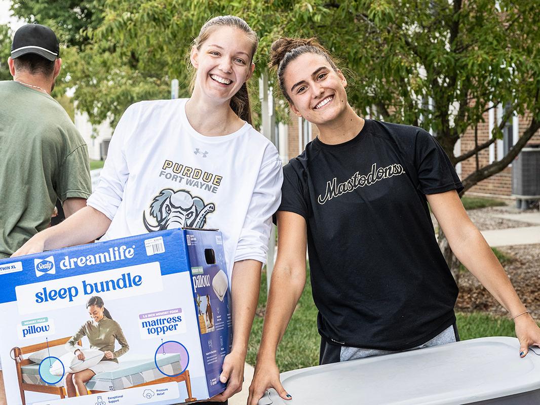 Two students are moving into student housing