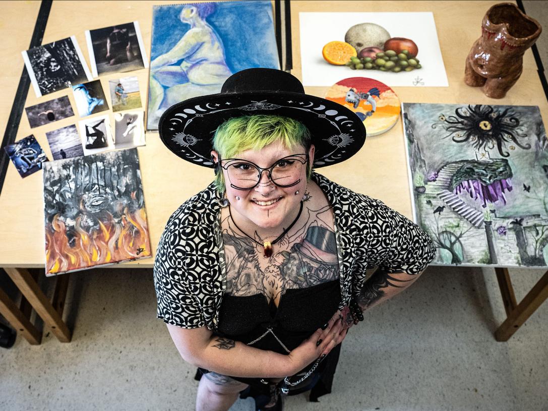 Dorian Soto surrounded by several of her works of art