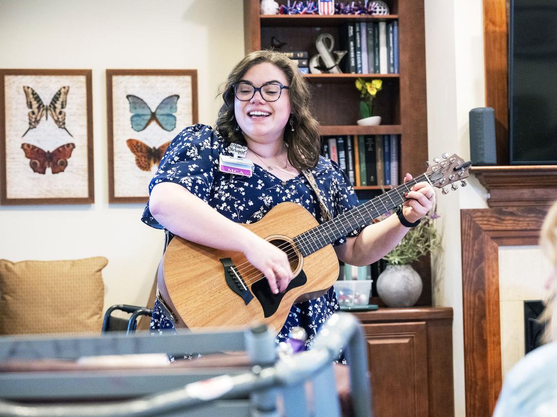 Brooke Sullivan is accompanying herself on the guitar while singing
