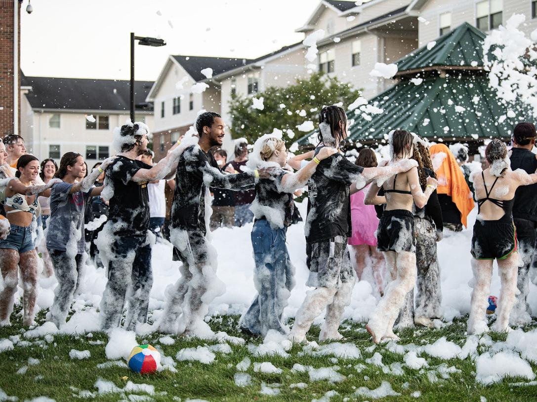 Students line dancing at the Foam Party at the Disco
