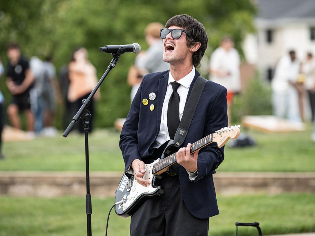 Noah Sties is singing and playing a guitar