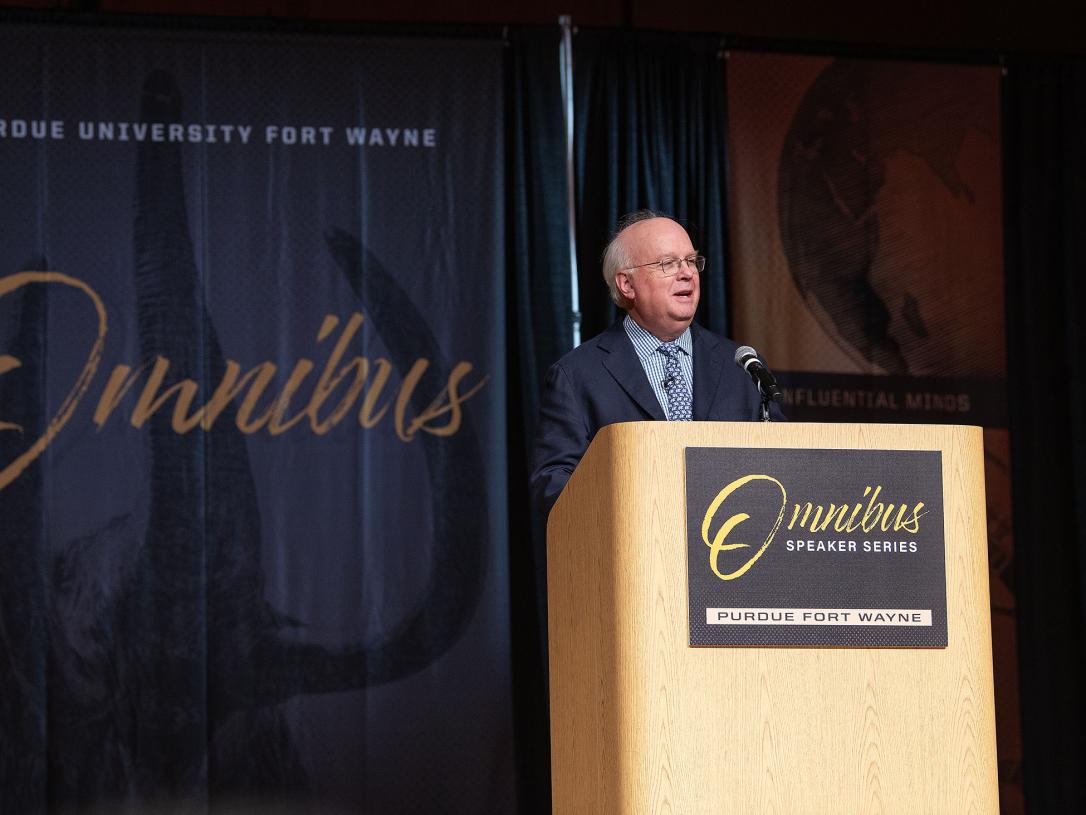 Karl Rove is speaking to the audience in Auer Performance Hall