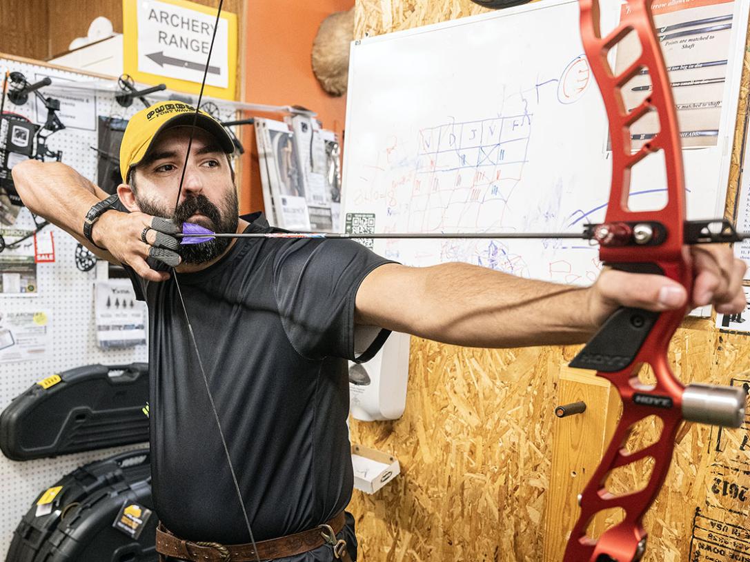 Cadd Amsler is drawing back an arrow