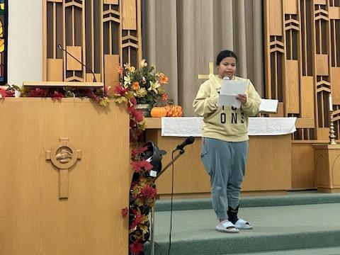 A sociology student is speaking at a church