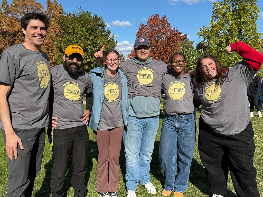 Dr. Odden poses with students during an Anthropology event.