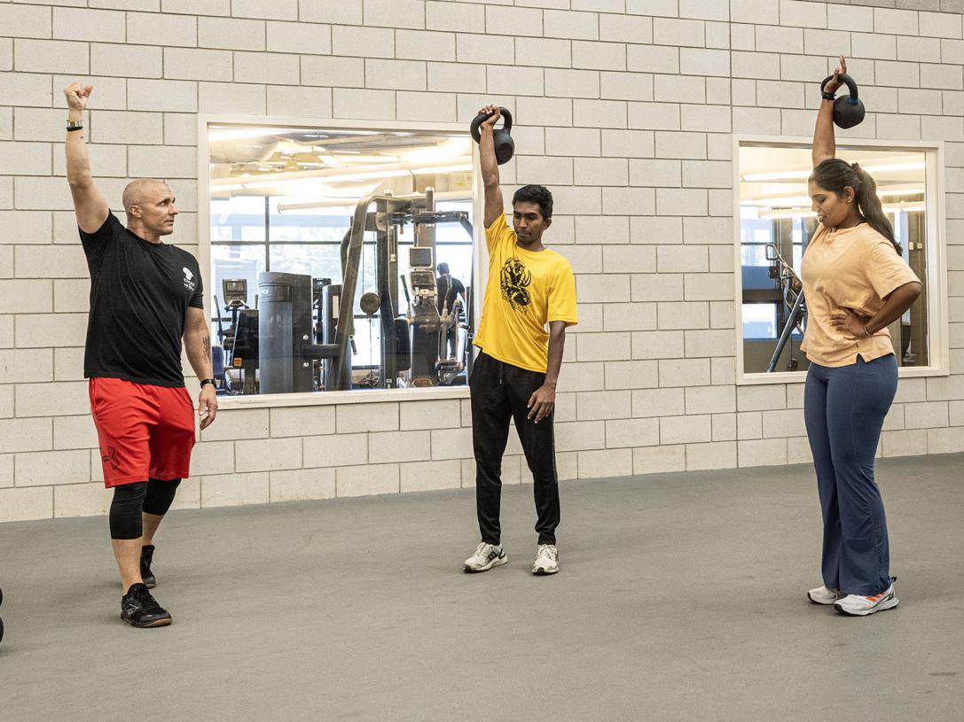 A police officer is leading a CrossFit class