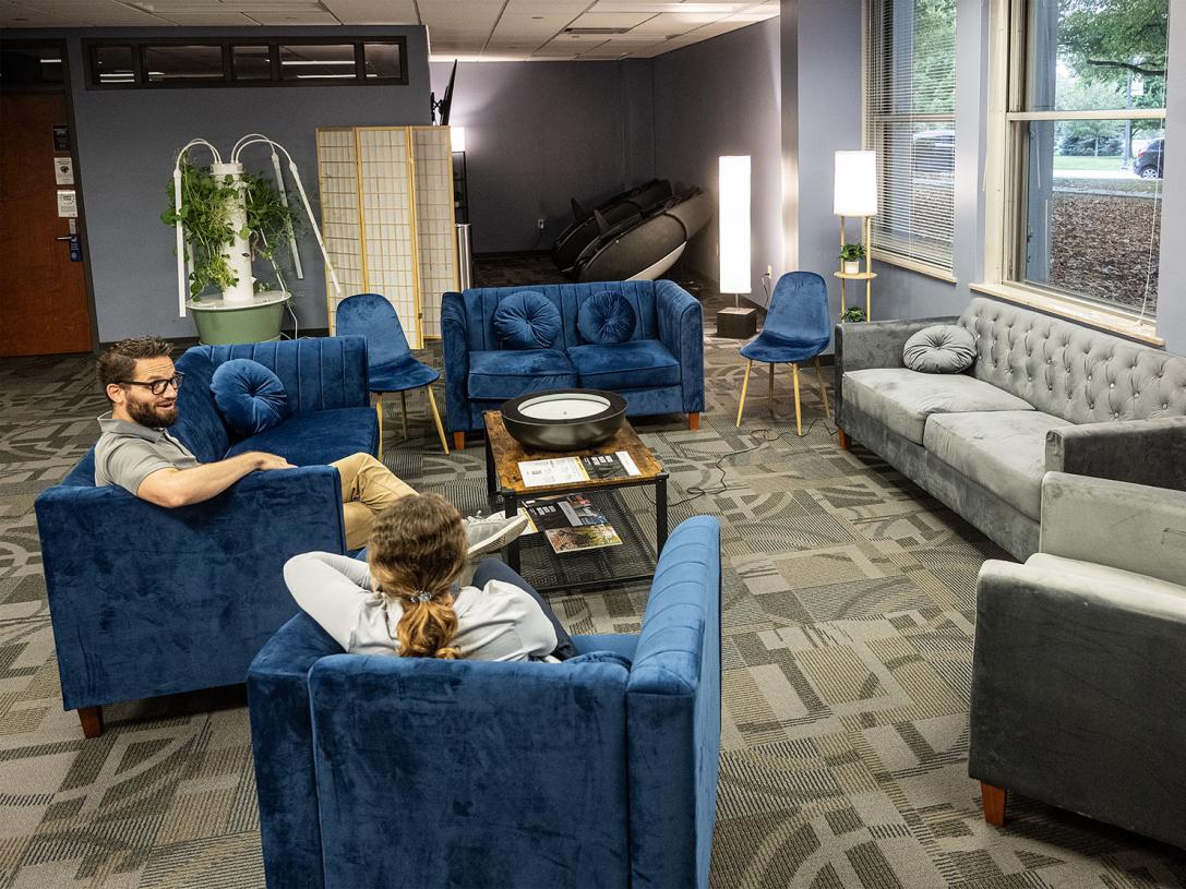 Two people relaxing on easy chairs