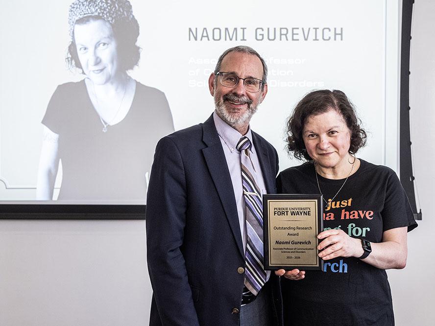 Dean Ron Friedman is presenting an award to Naomi Gurevich