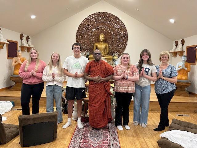 Sociology students with a Buddhist monk in a temple