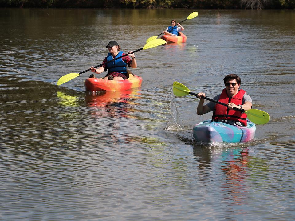 Dr. Odden races a student on a kayak