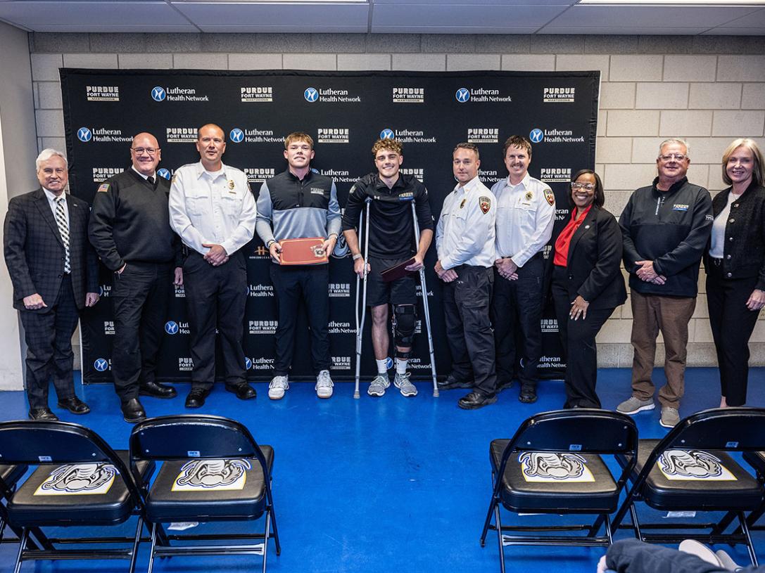Several people are gathered for an award ceremony