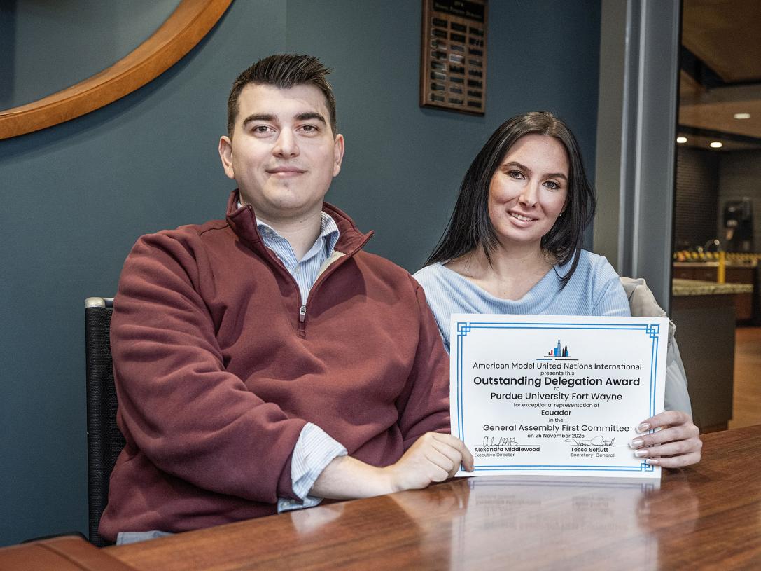 Nate Wilcox and Matilda Radcliffe display their award
