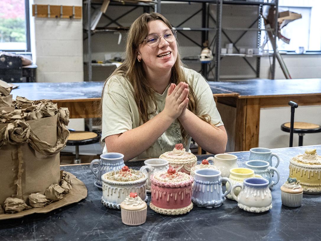 Teagan Koble with several of her ceramic pieces