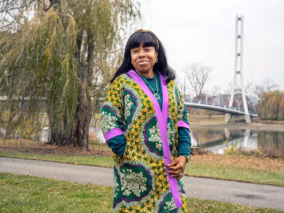 Stacy Abraham is on campus standing near a bridge