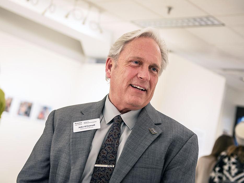 John O'Connell talking to someone at a gathering