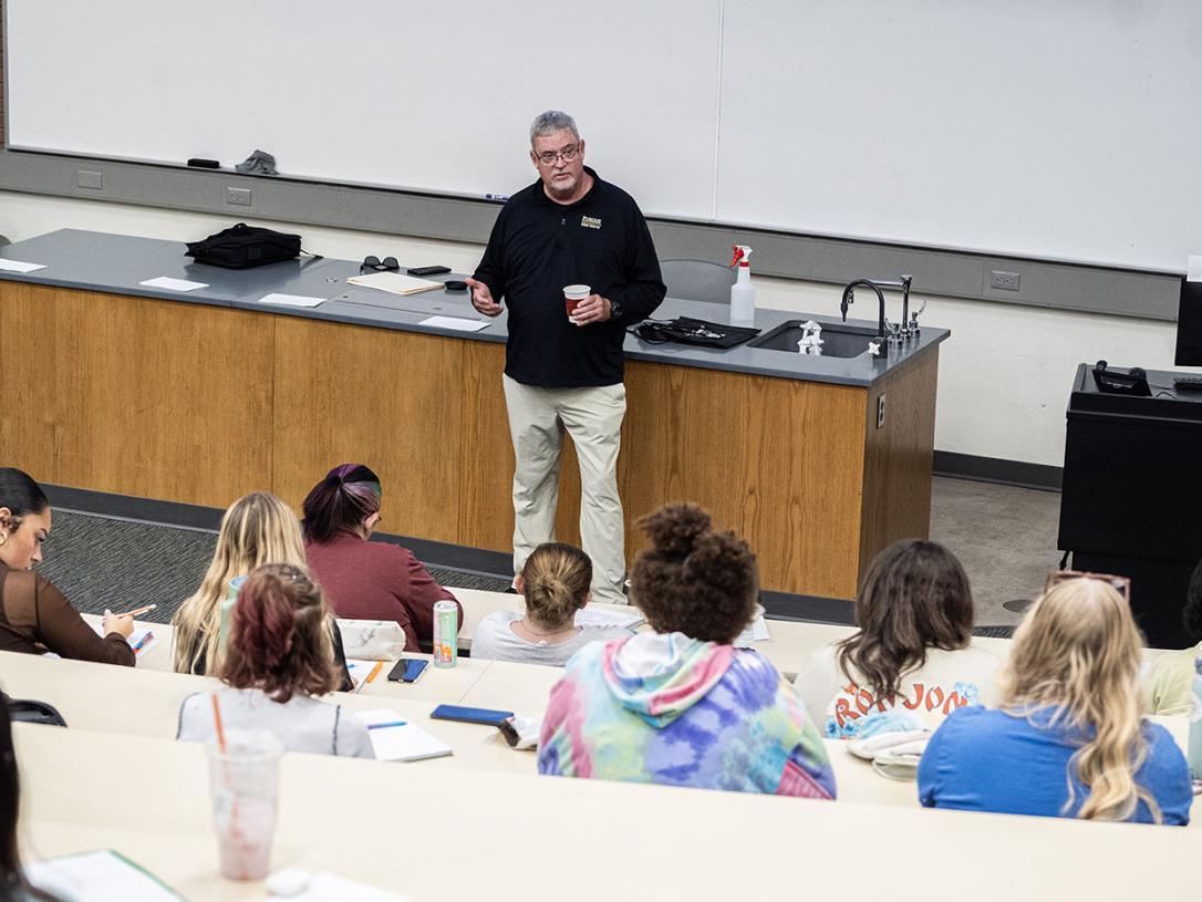 Carl Drummond is teaching a class in a lecture hall