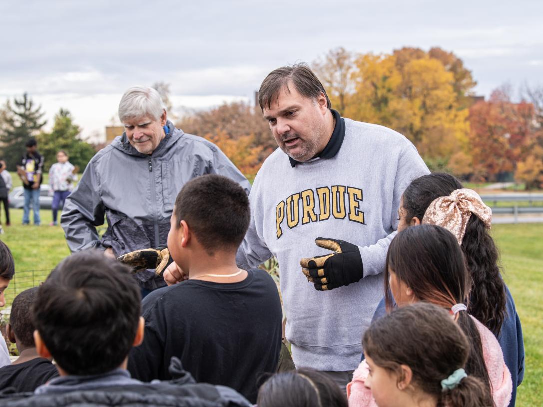 Young students working outdoors with instructor