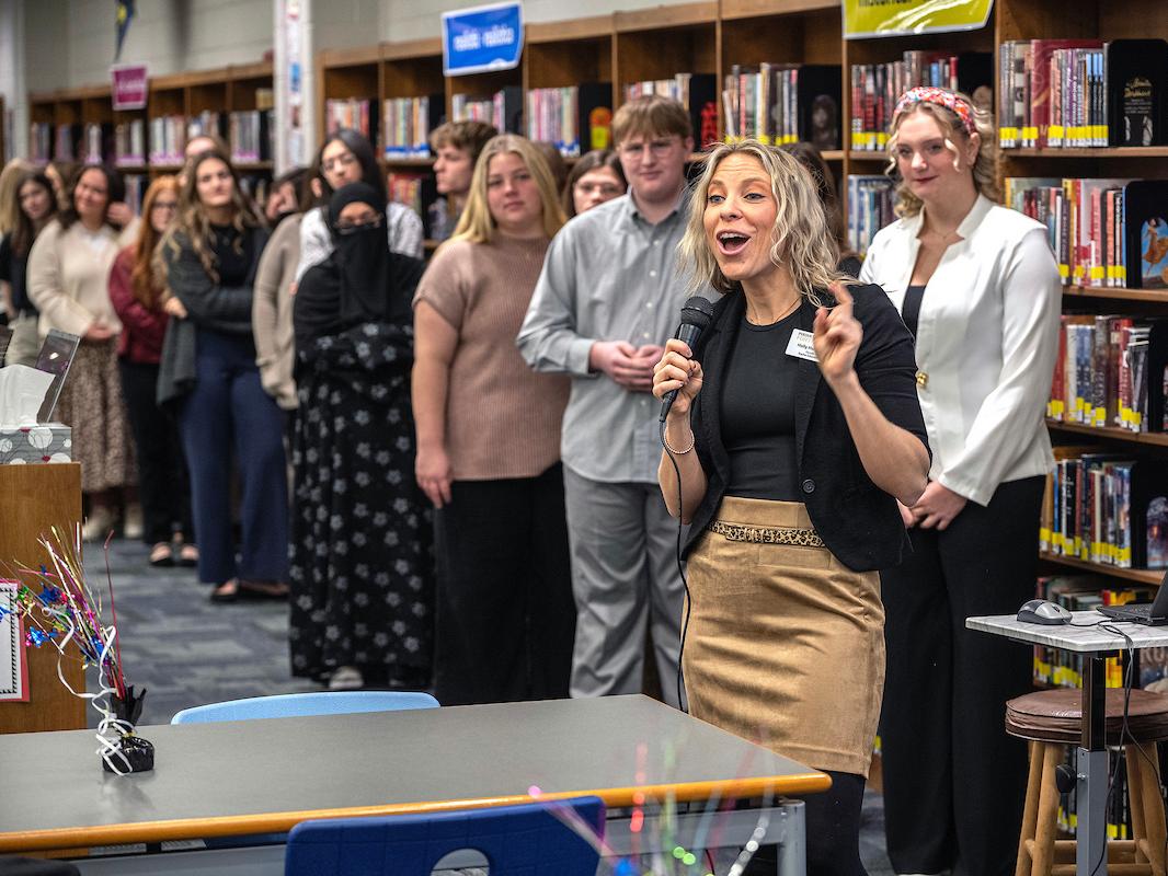 School of education students are lined up in front of a classroom