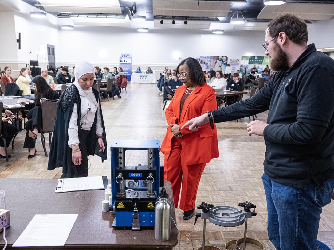 Mayor Sharon Tucker is talking to attendees at a conference