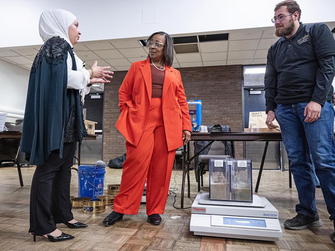 Mayor Sharon Tucker is talking to attendees at a conference