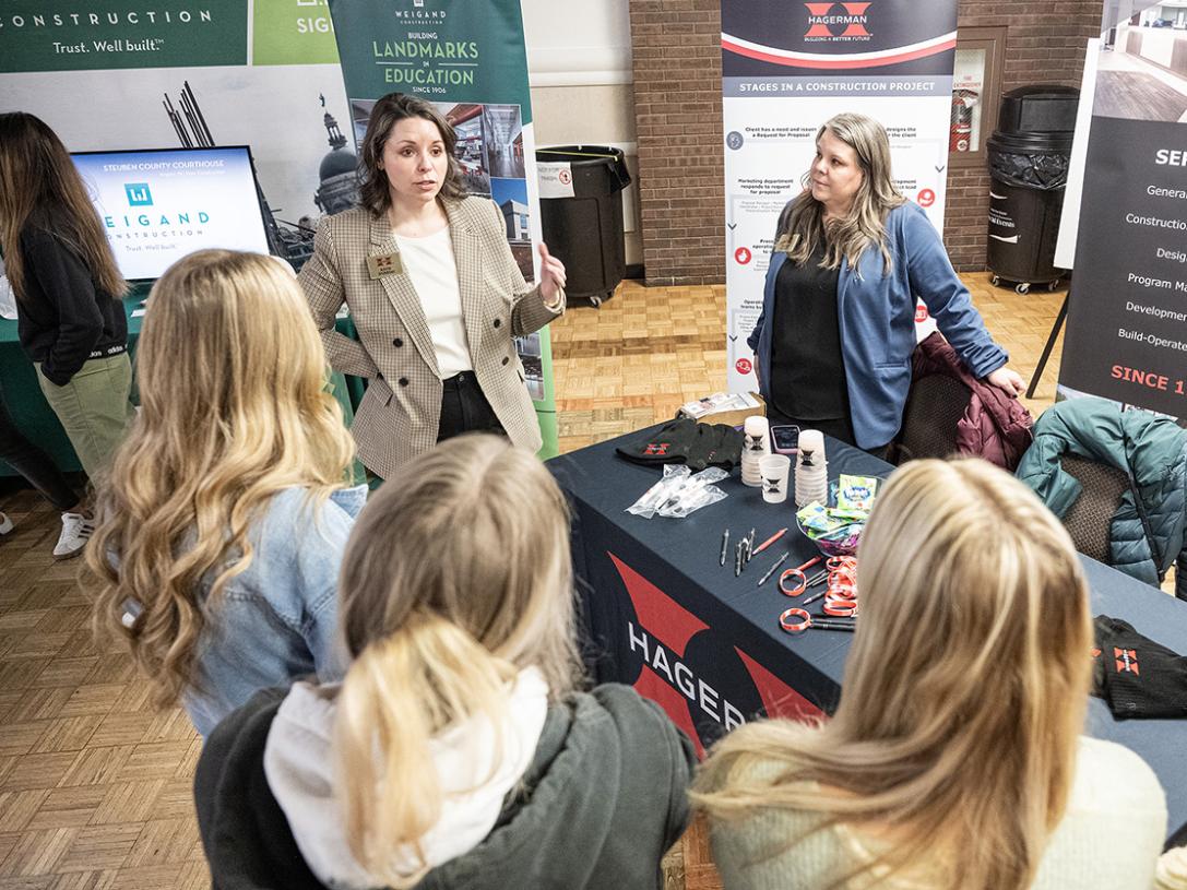 Attendees at a conference are speaking to each other