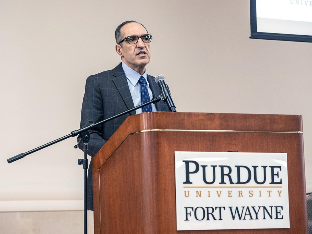 A college dean is speaking to an audience