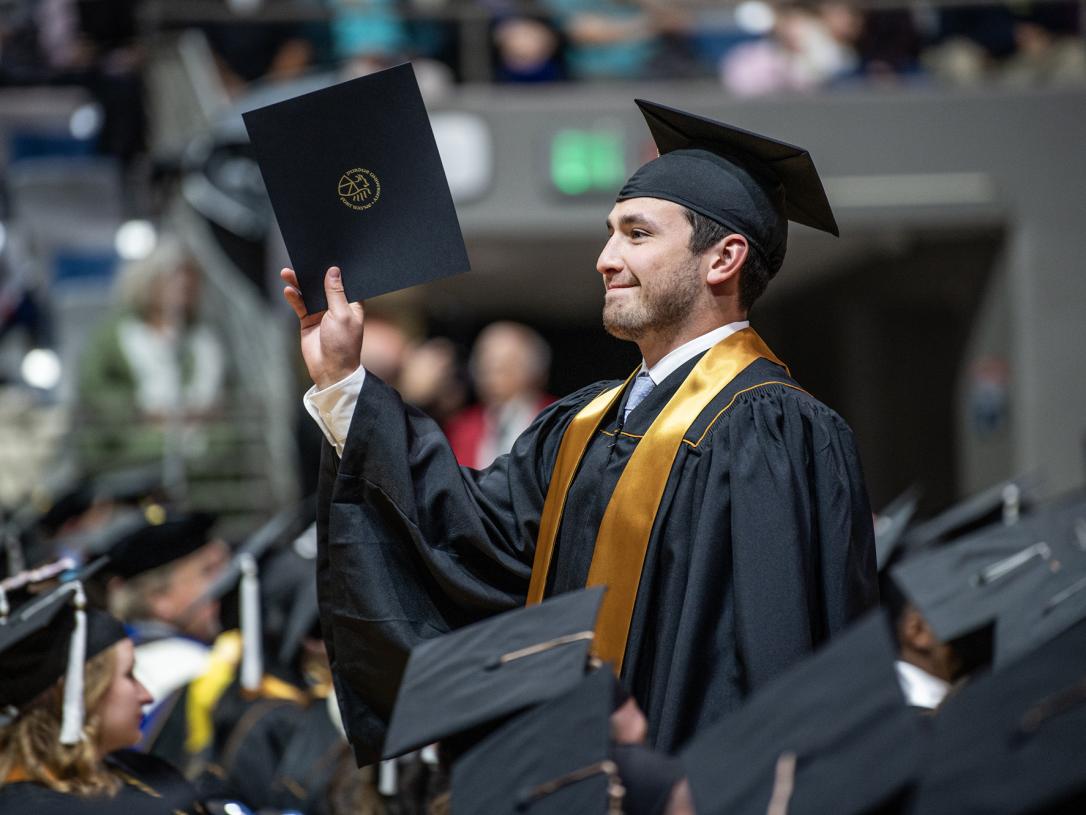A student recieves a degree at the 2026 commencement ceremony
