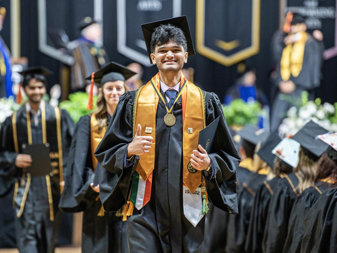 A student walks down the aisle at the 2026 commencement ceremony